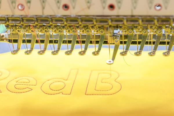 Computerized embroidery machines. sewing machine on blurred background. textile workshop. closeup.