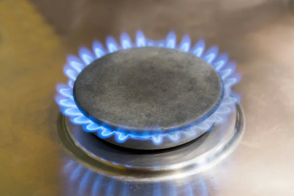 Burning blue flame gas burner on the washed plate