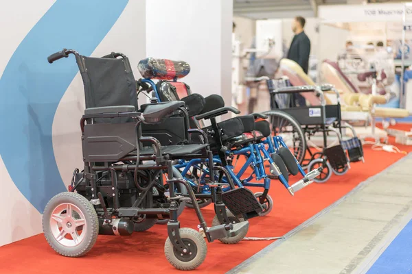 Wheelchair at a medical exhibition. Wheelchair with electric motor.