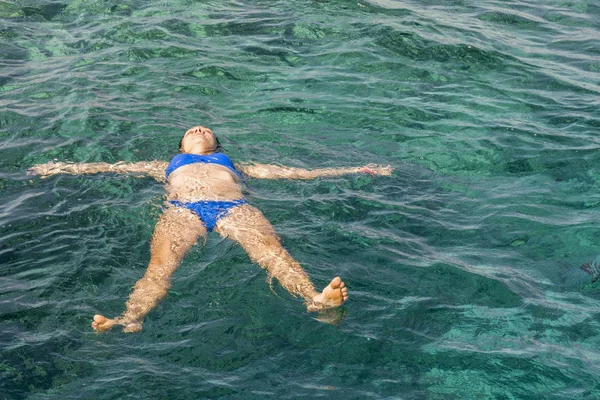 Woman swiming in the sea. Beautiful girl swiming at tropical island