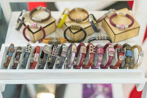 Stylish leather bracelets in the shop. Many various leather and textile bracelets. Leather multi-colored bracelets in the shop.