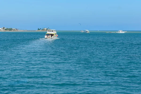 several pleasure boats in the sea near the islands. boats in beautiful turquoise ocean near an island