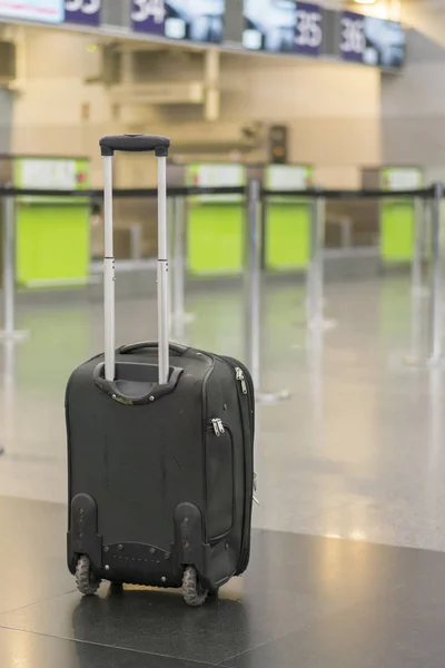 lonely suitcase at the airport. lonely suitcase at the airport. Forgotten baggage at an empty airport. vertical photo.