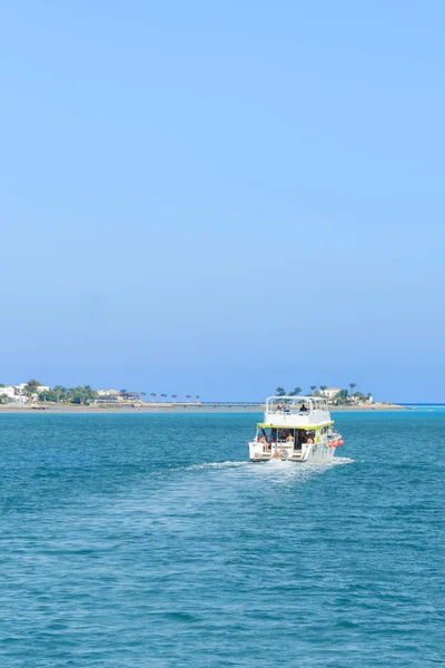 The boat goes on the open sea. aerial view of cruise tourist travel boat going on the sea. vertical photo