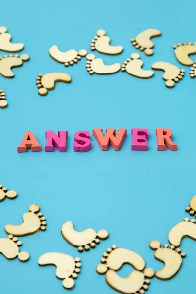 Answer Search Concepts. Concepts search answer. footprints and the word answer on a blue background. vertical photo
