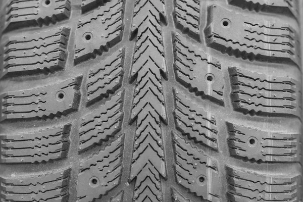 Close-up winter tire tread. Textured tire tread. Part of brand new modern winter car tire