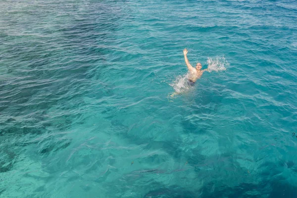 Drowning man in sea asking for help with raised arms. The man is drowning in the sea. man drowning in the sea and waving hand for help