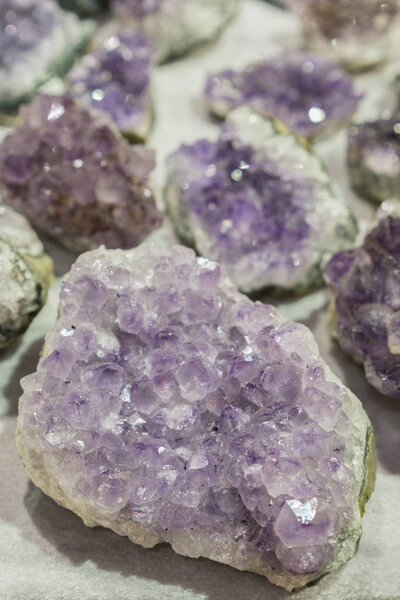 Inside of amathyst quartz geode. aquamarine natural quartz blue gem geological crystals texture background. vertical photo.