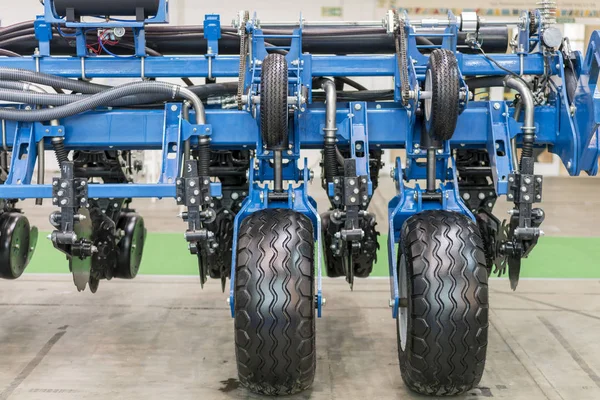 Part of the new agricultural technology. Corn harvester head with several silver blades. Agricultural machinery for soil cultivation