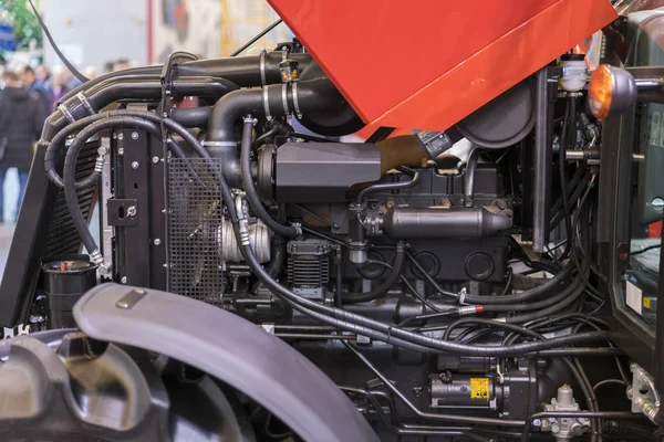 Modern new agricultural diesel tractor engine. Modern new hi-tech engine of loader or small tractor. Top view. The big new engine on a show window.