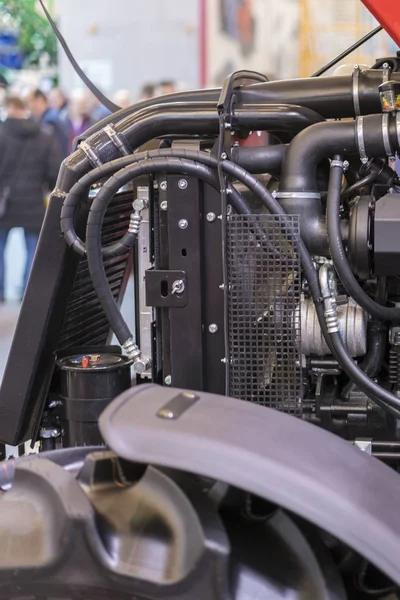 Modern new agricultural diesel tractor engine. Modern new hi-tech engine of loader or small tractor. Top view. The big new engine on a show window. vertical photo.