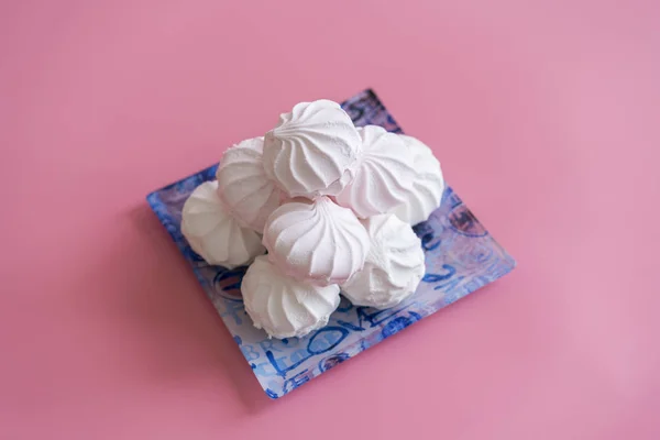 Pink and white marshmallows on a pink background. copy space