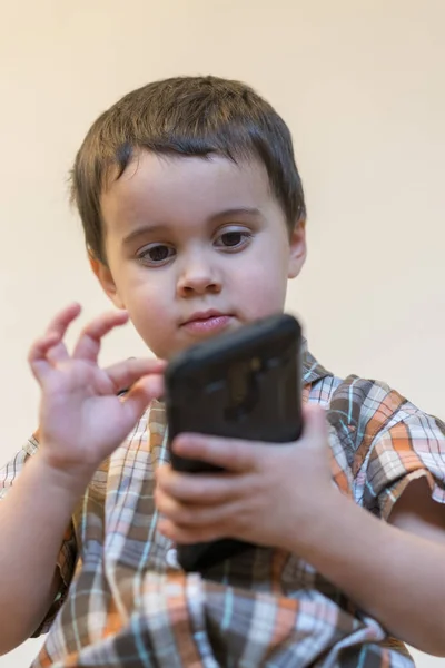 Cep Telefonu Açık Renkli Izole Tutmak Gülümseyen Bir Küçük Çocuk — Stok fotoğraf