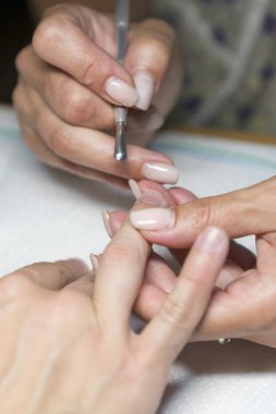 Tırnak dükkanında manikür işlemi sırasında kadın eli kapatın. Güzel bir konsept. kadın tırnak manikür işleme. dikey fotoğraf.
