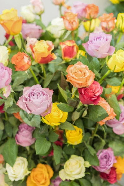 Bright multicolored bouquet of roses. Natural flowers background, soft focus. Colorful roses flower background, group of multicolor rose make from clay, handmade product. vertical photo