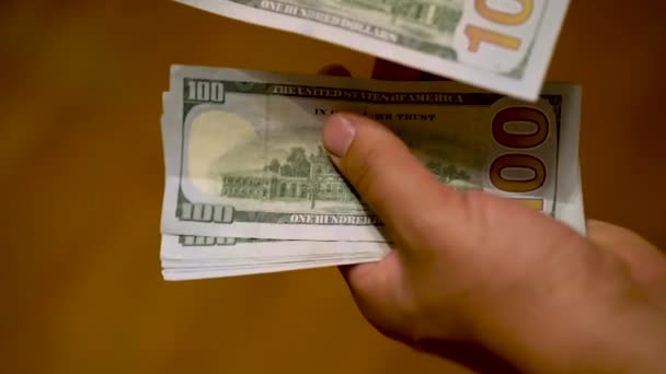 Muž počítá dolary do svých rukou. Podnikatel počítá dolary do rukou. Dolary v mužských rukách, záběr zblízka. Muži přepočítávají 1000 dolarů — Stock video