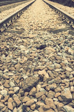 Arka planda çakıl ve demiryolu var. Eski demiryolu. Ton gibi. dikey resim