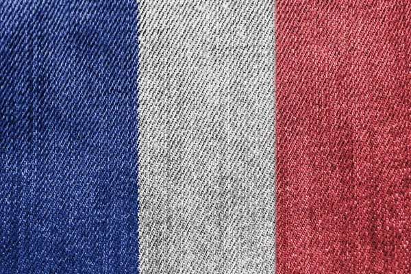 Francia Concetto di industria tessile o politica: Jeans denim con bandiera francese — Foto Stock