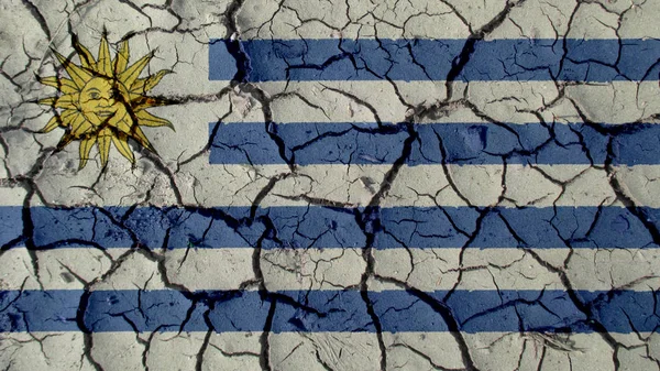 Concepto de crisis: Grietas de barro con bandera de Uruguay —  Fotos de Stock