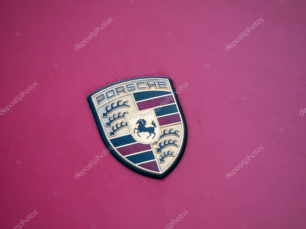 BERLIN, GERMANY - JUNE 1, 2019: The Logo of Porsche On A Purple Car