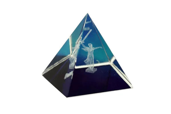 Glass dark blue transparent pyramid with the hologram of a woman isolated on a white background. Female raises her sword up. The concept of Motherland is calling. Stock Image