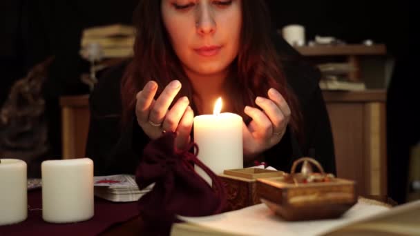 Witch Fortune Teller Black Mantle Rings Blows Out White Candle — Stock Video