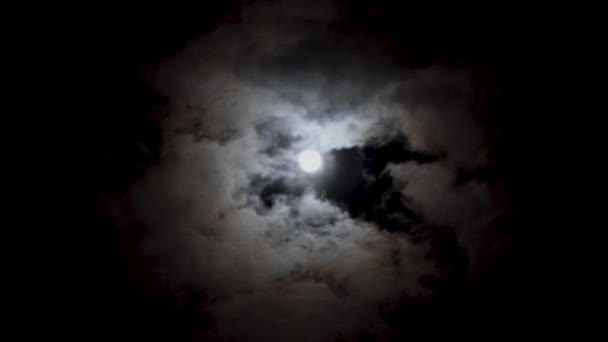曇りの日に夜の青空に月を夢見る ボリュームふわふわ雲の間の明るい白い月 オオカミ時間 — ストック動画