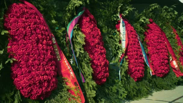 Beautiful Funeral Ritual Wreaths Red Flowers Green Spruce Ribbons Tomb — Stock Video