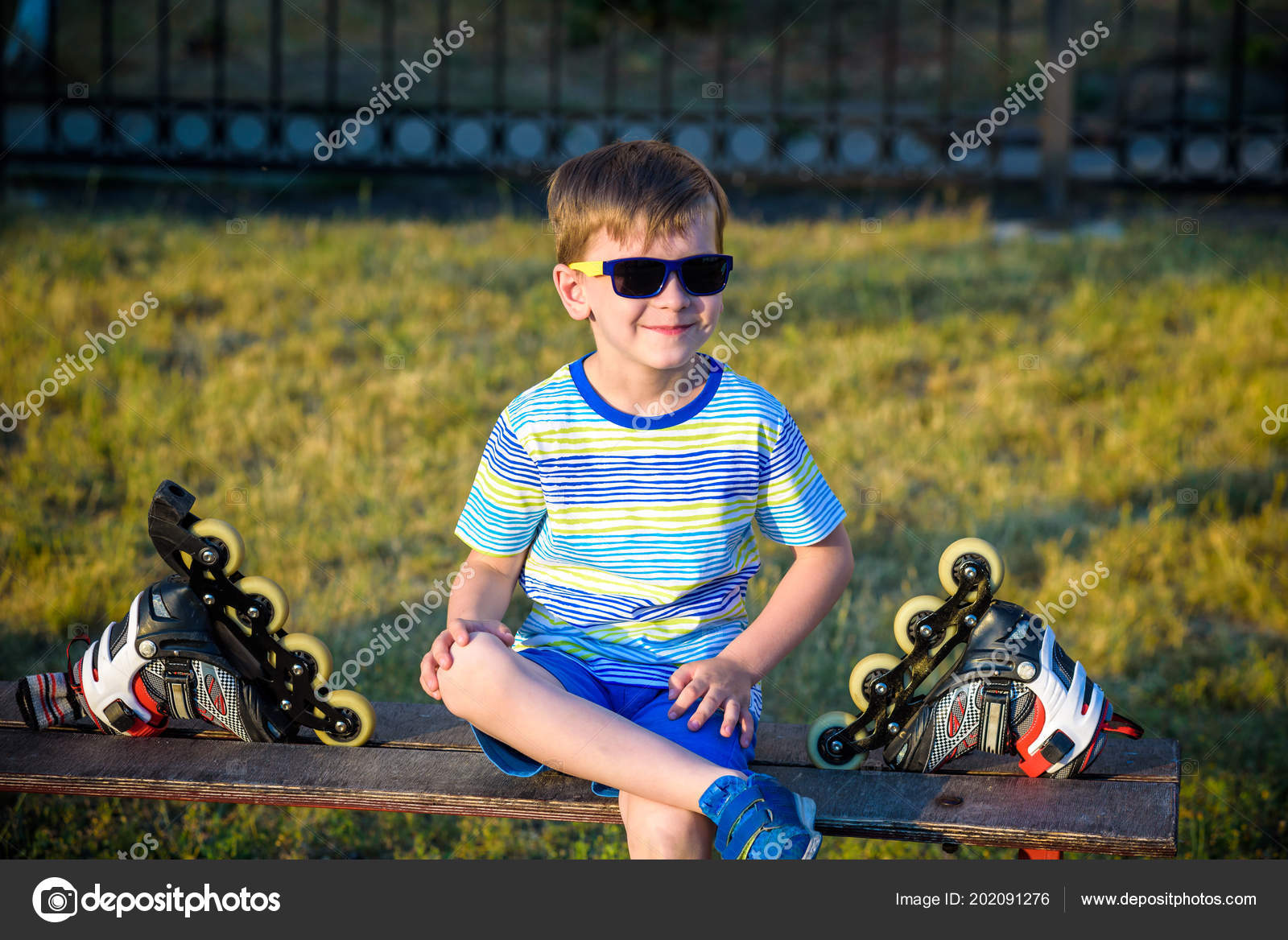 Little Handsome Boy Roller Blades Sits Bench Summer Park Happy