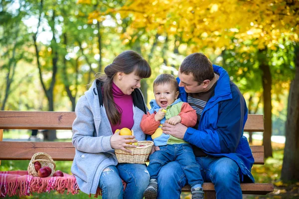 Ευτυχισμένη οικογένεια απολαμβάνει πικνίκ φθινόπωρο. Πατέρας μητέρα και γιος κάθονται o — Φωτογραφία Αρχείου