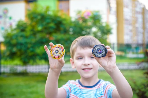 Boy playing with a spinning top outdoors