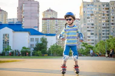Yazın Park'ta silindirlere binen küçük bir çocuk. Mutlu ch