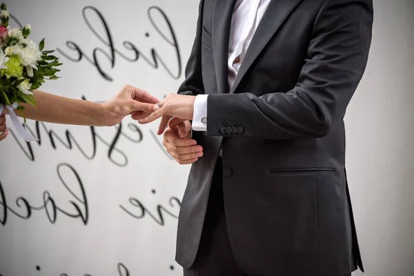 Hochzeitstag. Der Bräutigam legt den Ring an die Hand der Braut. Foto-Nahaufnahme — Stockfoto