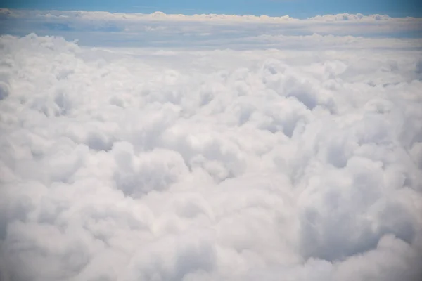 青空に白いふわふわの雲。旅客旅客機のポートホールからの雲の写真。写真の背景 — ストック写真