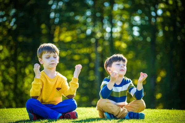 Zwei Kaukasische Jungenfreunde Sitzen Auf Frischem Grünen Rasen Und Meditieren — Stockfoto