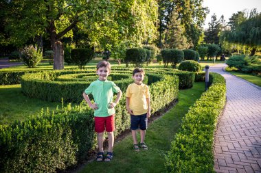 İki kardeş birlikte güzel yeşil parkta oynuyorlar. Mutlu aile en iyi iki kardeş bir arada duruyor. Kardeşler yaz aylarında dışarıda oynarlar..