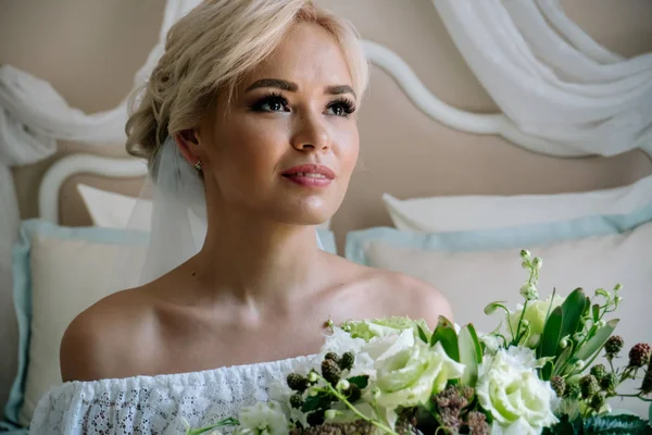 Красивая невеста в белом белье сидит на кровати в своей спальне — стоковое фото
