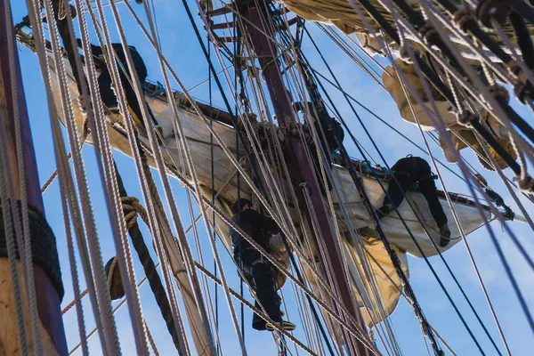 Námořníci práce s plachtami ve výšce na tradiční plachetnici — Stock fotografie