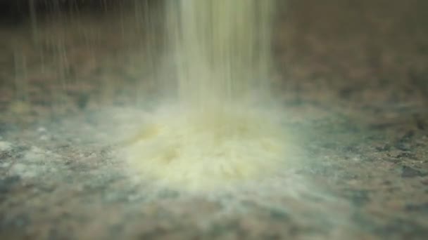 White flour is poured onto a stone table, slow motion — Stock Video