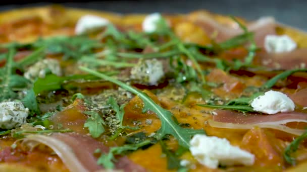 Fresh pizza with cheese, herbs, tomatoes, slow motion — Stock Video