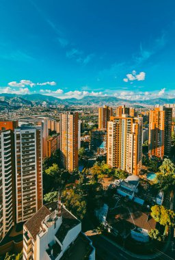 Medellin, Antioquia, Kolombiya. 13 Aralık 2020: Mavi gökyüzü ve binaları olan şehir manzarası.