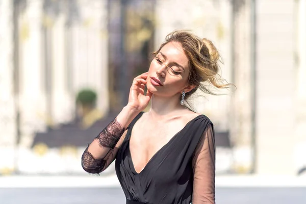 Mujer en un retrato al aire libre vestido negro. Las pasiones parecen enfoque suave —  Fotos de Stock