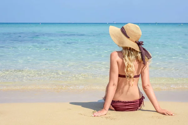 Woman at the beach in Cyprus. Hat and swimsuite. Beautiful Summer seaside views. Enjoying sunny days Stock Picture
