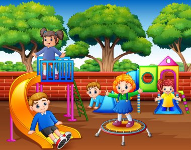 Happy children playing in the playground at daytime clipart