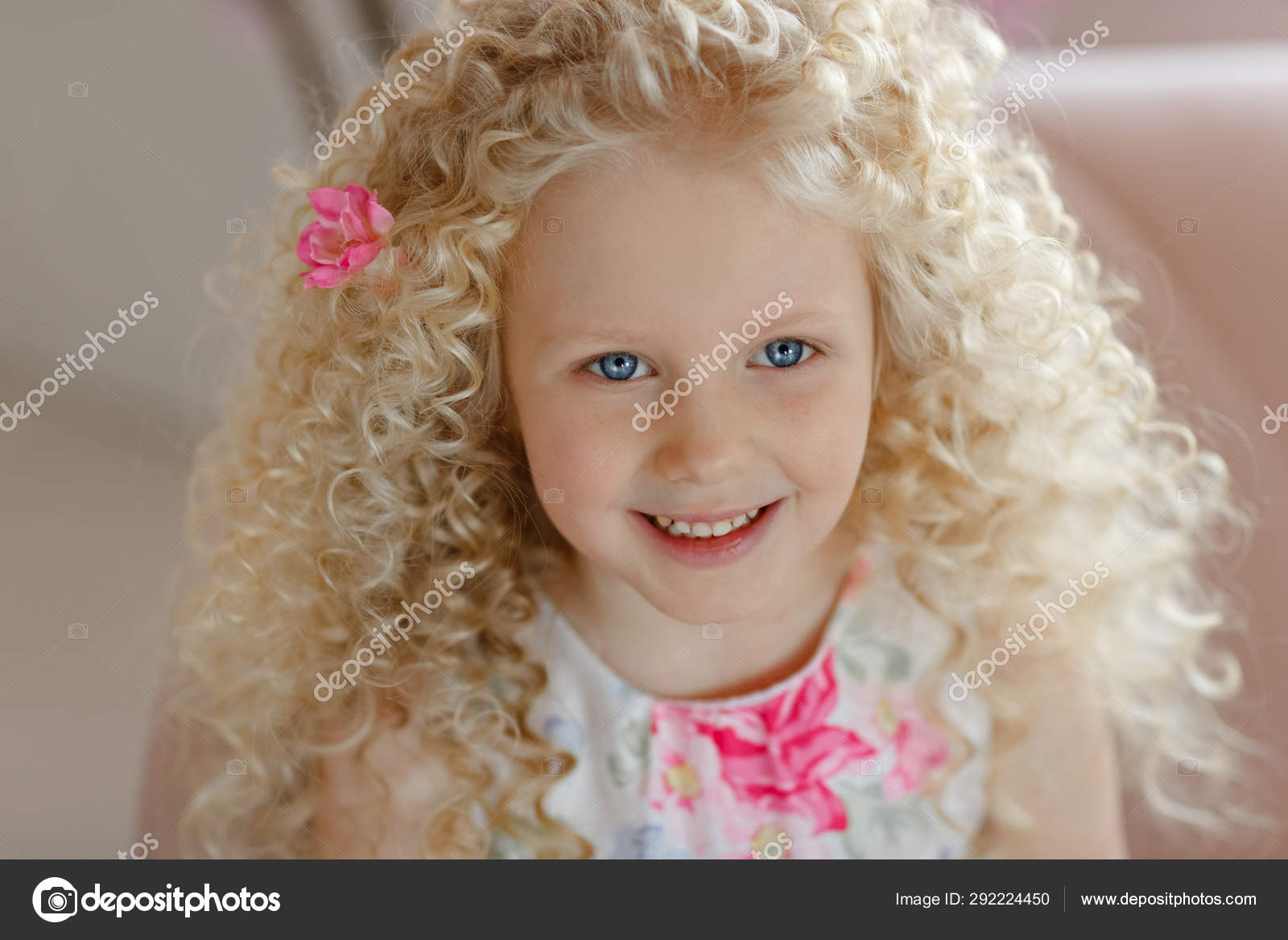 girl with curly blonde hair and blue eyes