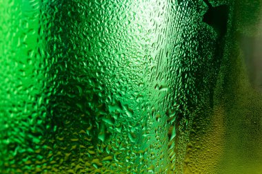 Su yeşil cam yüzeyde yoğunlaşmış soyut arkaplan.