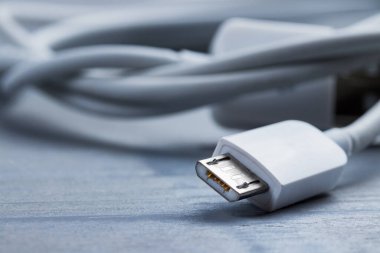 Mikro usb akıllı telefon güç kablosunun ahşap bir arka planda yakınlaştırılması.