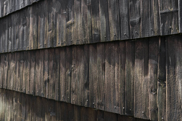 Natural dark stained wood building wall background.