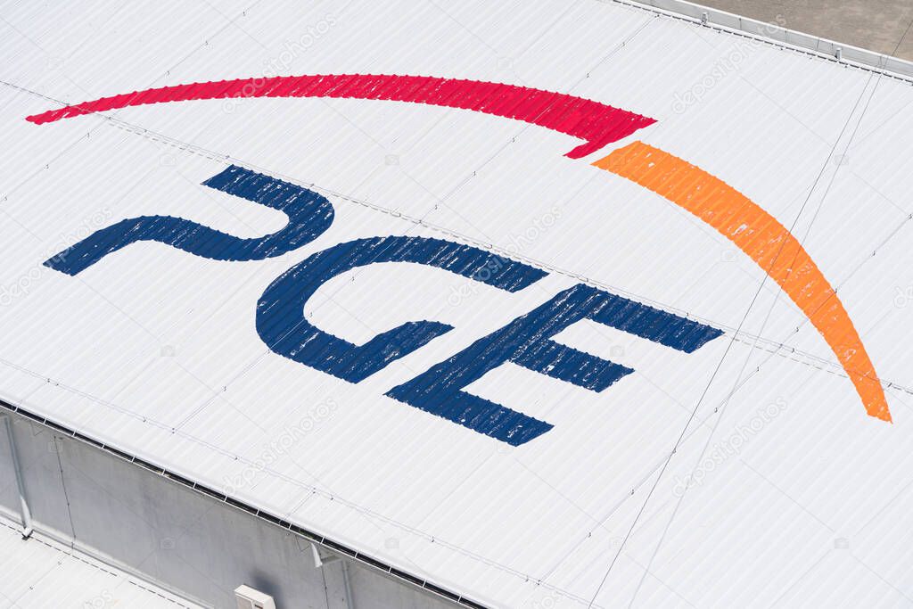 Solina, Poland - June 24, 2019: Polska Grupa Energetyczna (PGE) logo near Solina Dam in Poland. PGE Capital Group is Polands largest energy sector company with respect to sales, revenue and net profit.