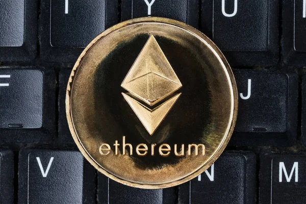 stock image Gold physical Ethereum coin on computer keyboard. Cryptocurrency shopping abstract concept.